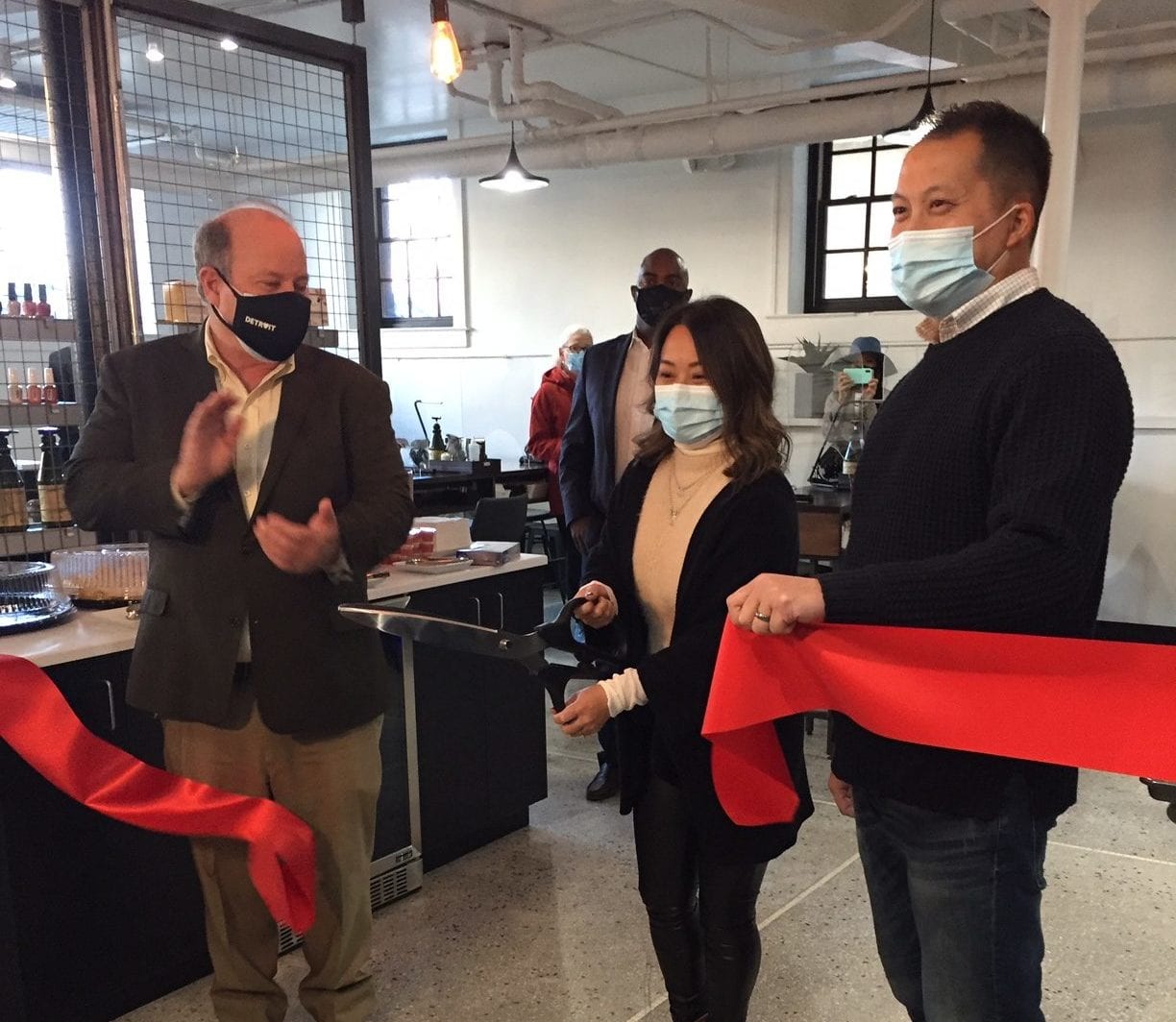 Owner cutting ribbon at ceremony