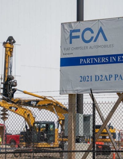Construction site with an FCA billboard in the front.
